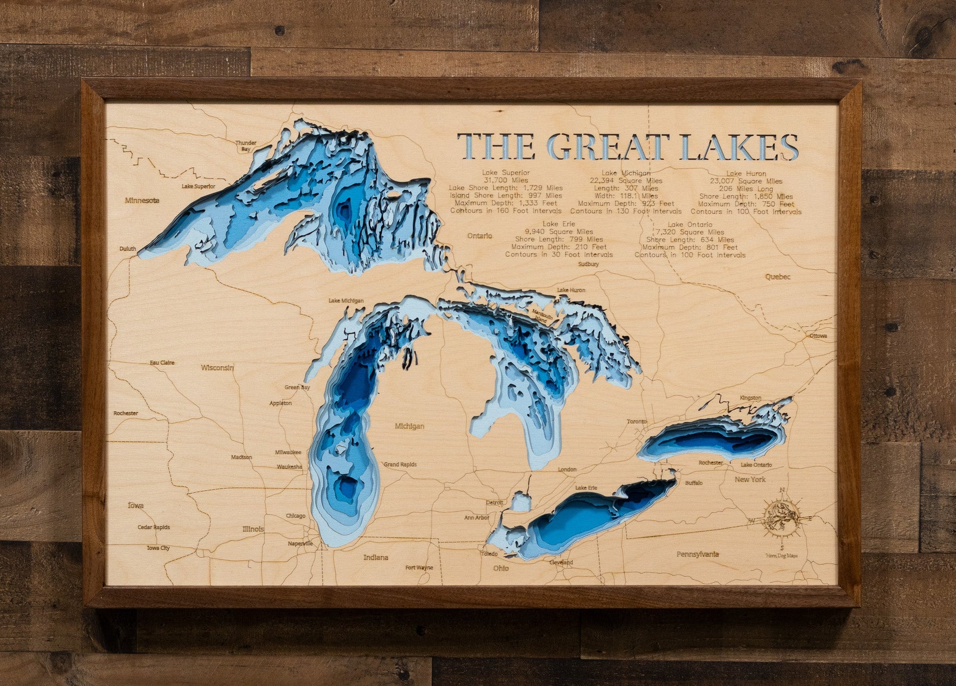 Wooden map of The Great Lakes with topographic details on a wooden background