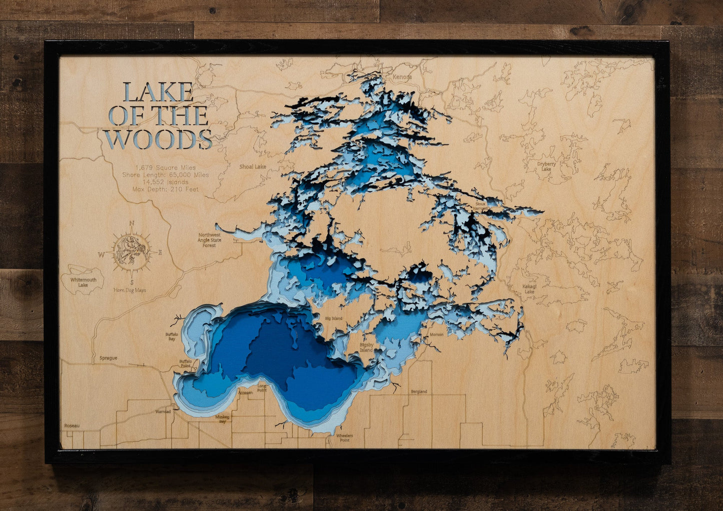 Wooden map of Lake of the Woods with blue water features on a wooden background