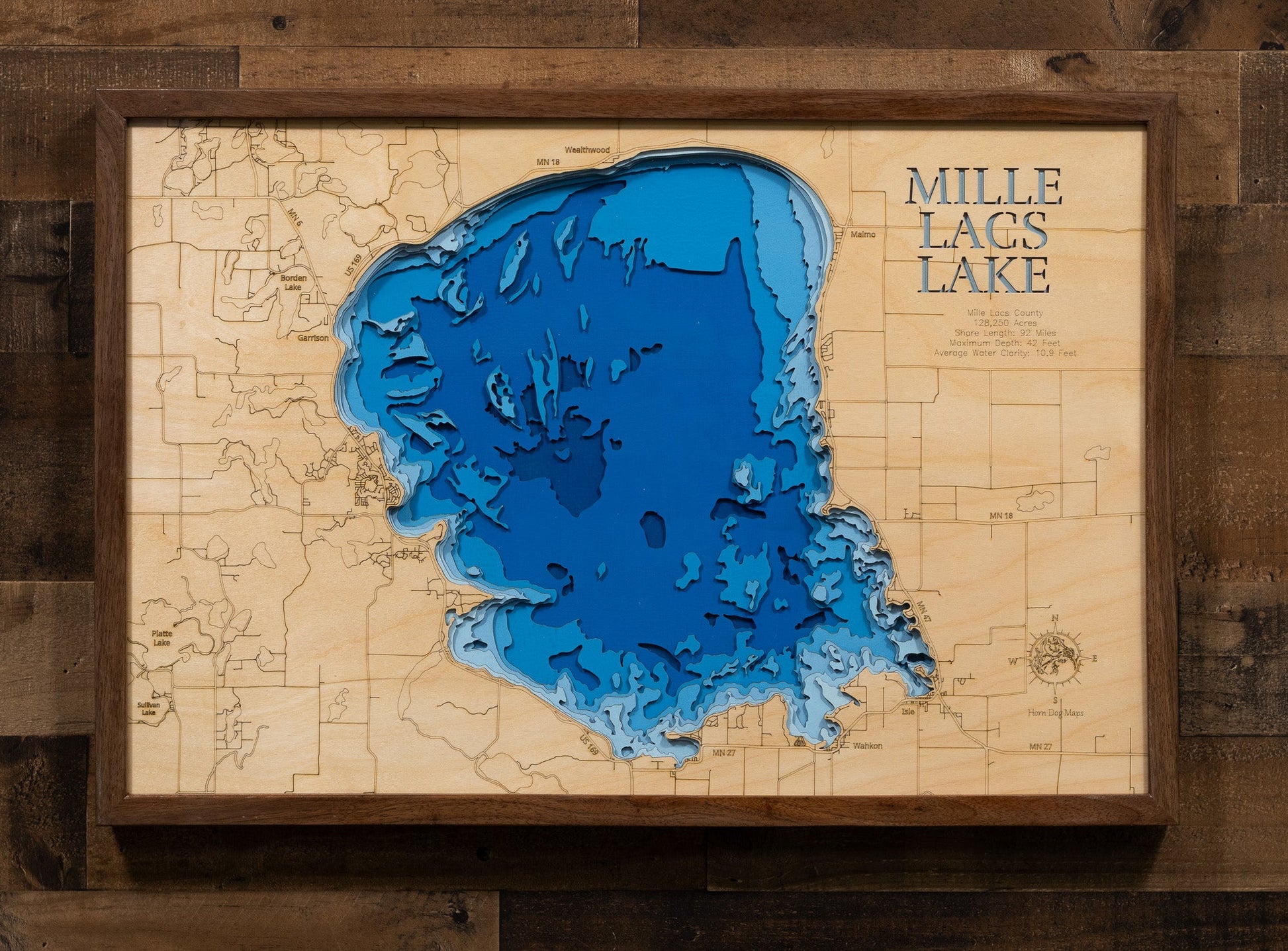 Topographic map of Mille Lacs Lake with a wooden frame on a wooden wall.