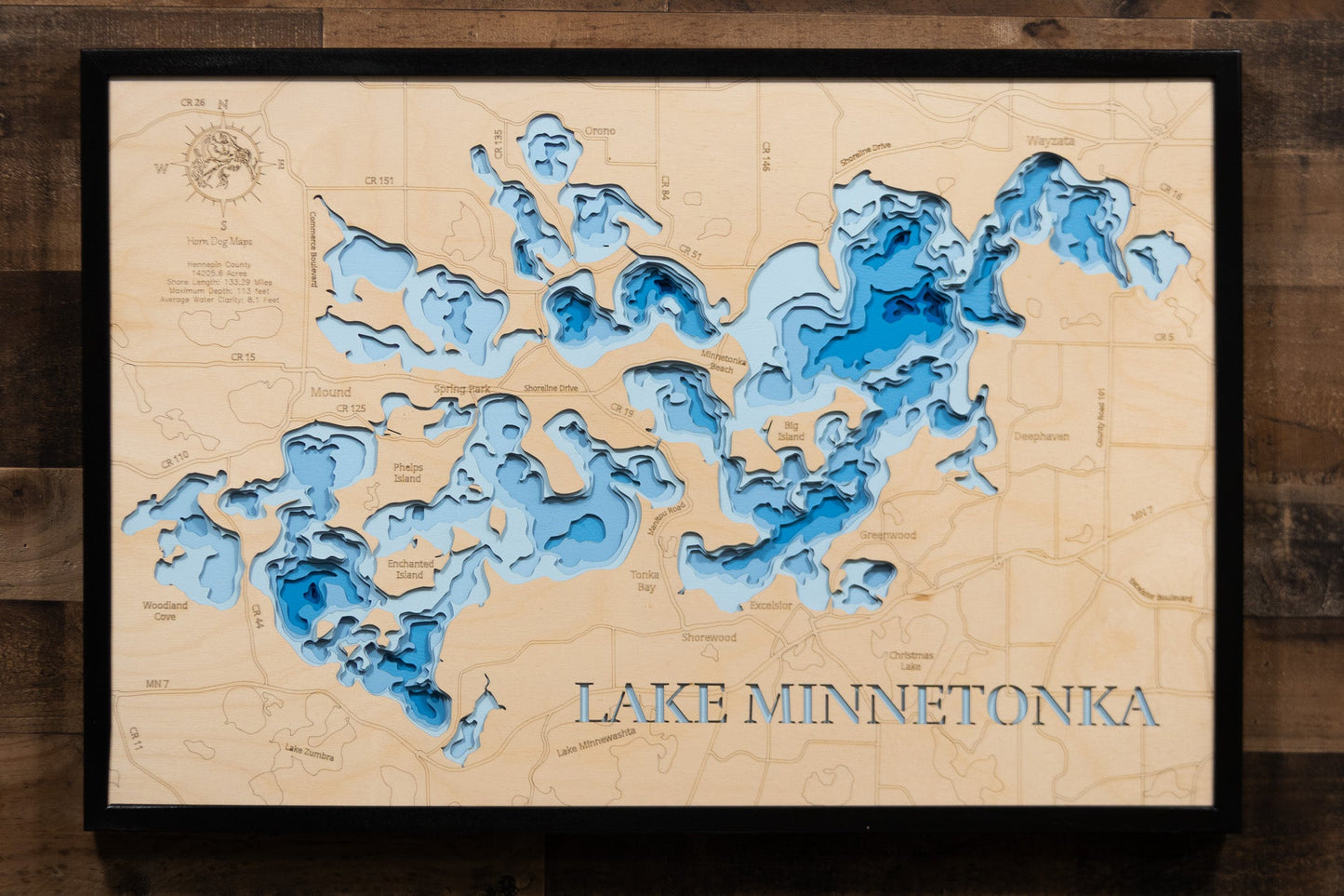 Wooden map of Lake Minnetonka with blue water features on a wooden background