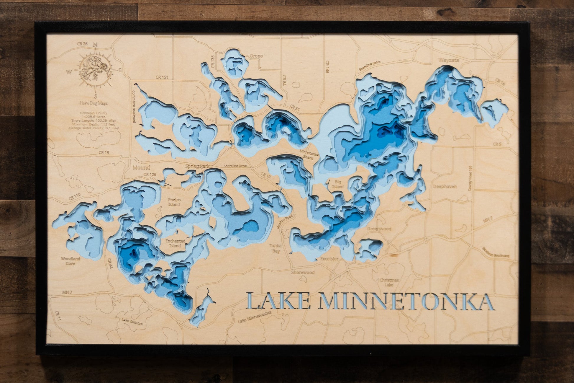 Wooden map of Lake Minnetonka with blue water features on a wooden background