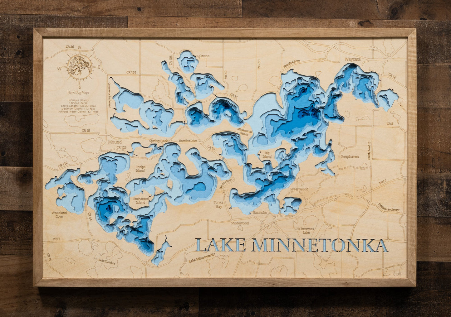 Wooden topographic map of Lake Minnetonka with blue water features on a wooden background