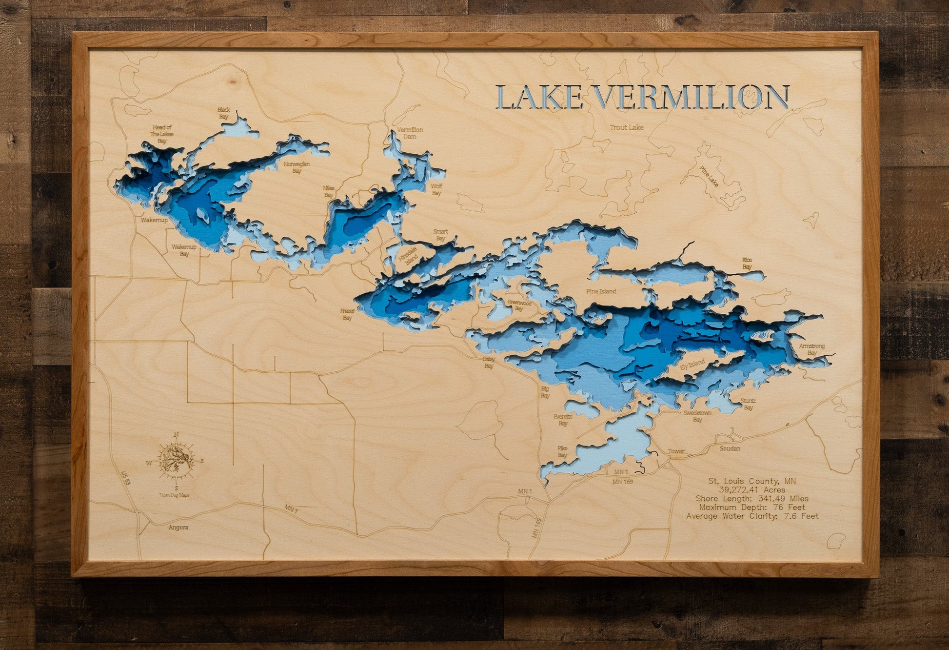 Wooden map of Lake Vermilion with raised relief details on a wooden background