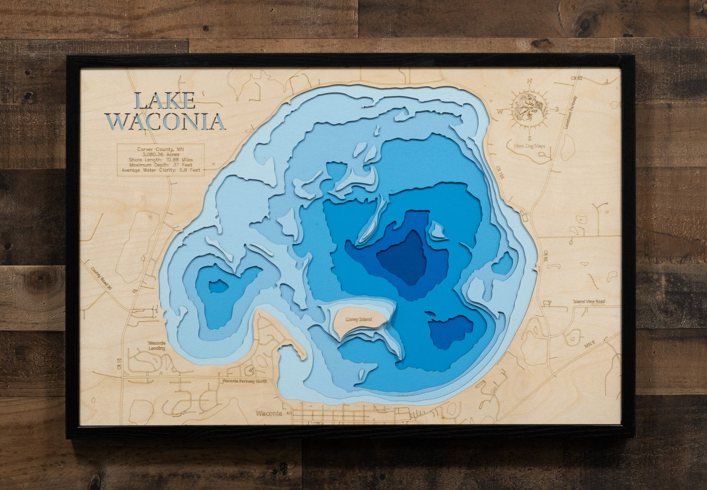 Topographic map of Lake Waconia on a wooden panel with a black frame.