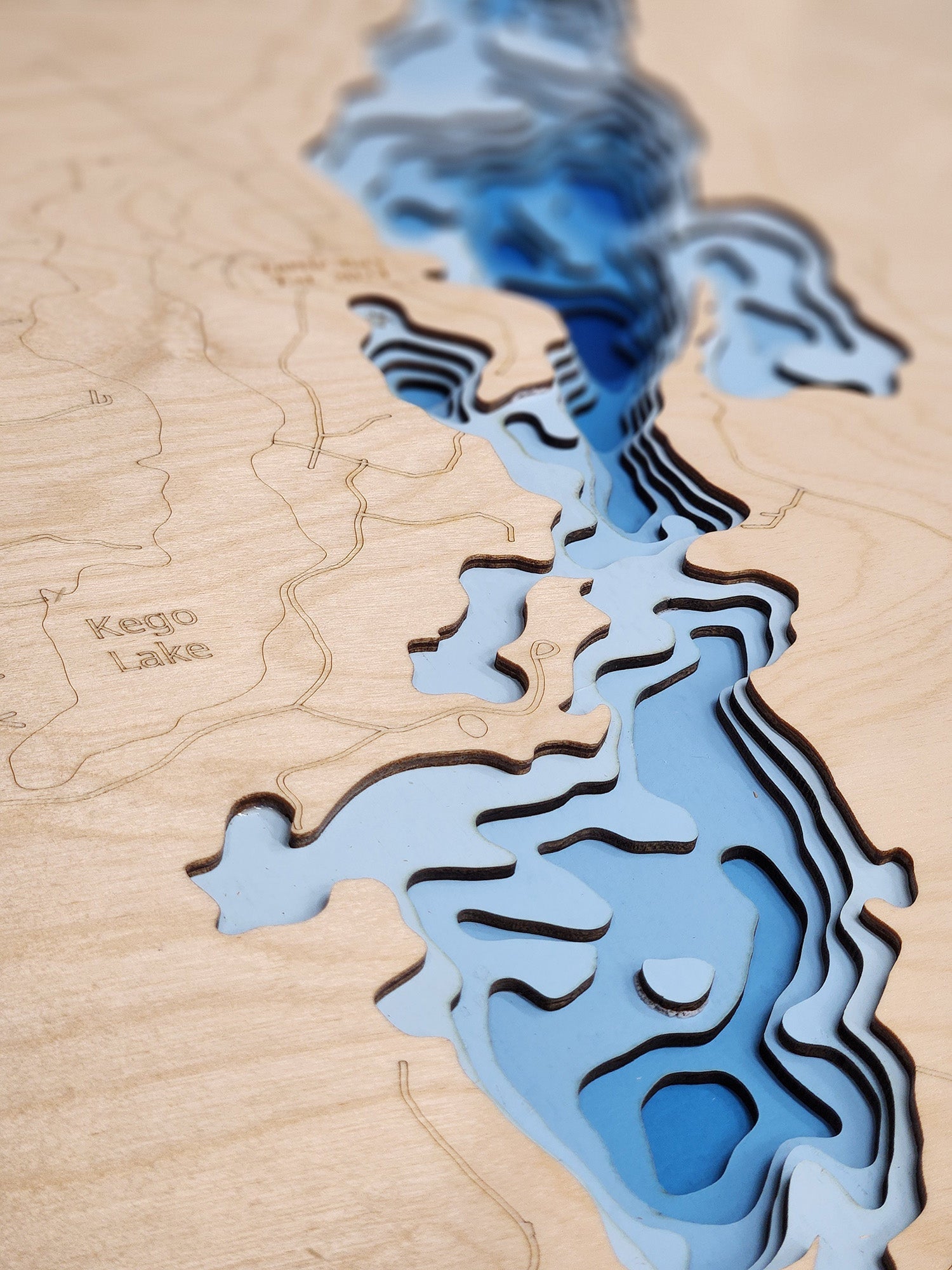 Topographic map of Kego Lake on a wooden surface